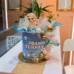 Let it go! A Frozen-themed cake for Joanna's third birthday. This design features a blue and purple watercolor effect, edible snowflakes, shimmering wafer paper sails, and an Elsa topper to bring the magic to life.
