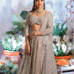 For this beautiful reception look, I designed a complete head-to-toe style. The makeup features a flawless base with a bold red lip, paired with a sleek high ponytail to complement her dazzling silver lehenga. It’s all about creating a cohesive and glamorous statement.