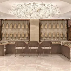 The centerpiece of the gold showroom, featuring a stunning custom chandelier that draws the eye. We designed this central display area to be a focal point, exuding luxury and highlighting the most exclusive collections.