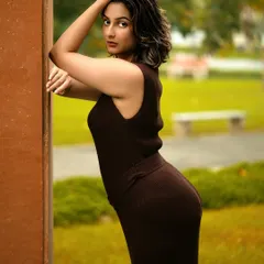 A different pose from the same series, showcasing the model's profile and the dress's silhouette against a natural, green background. This adds variety and elegance to the set.