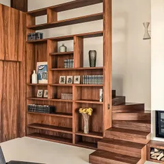 A floor-to-ceiling wooden bookshelf that also functions as a stylish staircase. This innovative design is a perfect example of how to combine storage and function in a unique and beautiful way.