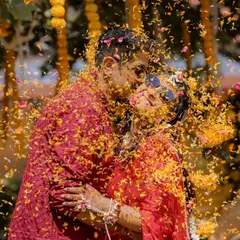 Haldi is all about pure, unadulterated joy. I love getting right into the middle of the celebration to capture moments like this one, a spontaneous kiss amidst a shower of marigold petals. These are the candid, colorful memories that you'll cherish forever.
