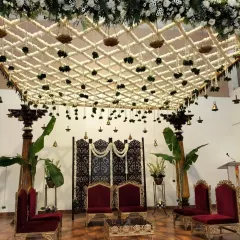 This traditional South Indian mandap showcases our expertise in intricate floral work. We created a stunning overhead lattice of fresh jasmine and tuberose, accented with hanging temple bells and banana leaf pillars, to craft a sacred and elegant ceremony space.