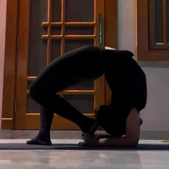 This is a deep backbend from a forearm stand, a pose that demands both shoulder strength and spinal flexibility. We work on opening the upper back and shoulders safely to make advanced postures like this accessible over time.