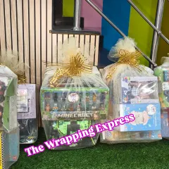 A collection of return gifts ready for a kid's party. This includes a Minecraft-themed hamper and other goodie bags filled with toys and stationery.