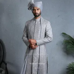 Inspired by Mughal grandeur, this powder blue sherwani is a vision of heritage. It is embroidered with intricate zari, handwoven florals, and sequins that sparkle like blessings, making it a living legacy carried forward with pride.