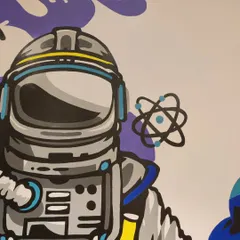 A detailed shot of the astronaut's helmet and the 'E=mc²' formula. Every part of this educational mural was designed to be visually appealing while connecting to the theme of science and discovery.