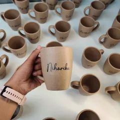 A close-up of our personalized bamboo husk mug. This eco-friendly material has a beautiful, natural texture, and the custom engraving adds a personal touch.