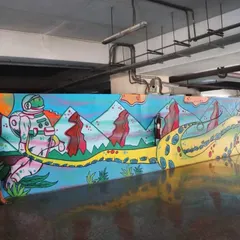 Standing with my finished mural at the WEH metro station. This piece featured a surreal landscape with an astronaut and octopus tentacles, designed to bring a sense of wonder and imagination to the underground space.