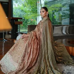 A dramatic shot showcasing the full effect of the double dupatta draping. The velvet shawl adds a layer of texture and royalty to the ensemble.