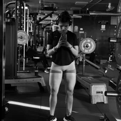 A black and white shot focusing on leg development. Using resistance bands is a great way to activate the glutes and leg muscles before a heavy lifting session.