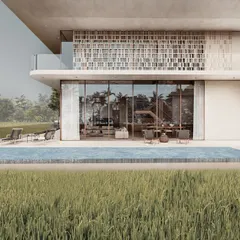 The infinity pool of a pavilion home is designed as a sharp edge of water that meets the soft texture of the paddy fields. This creates a seamless transition from the curated space of the home to the wildness of the surrounding landscape.