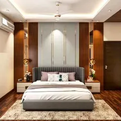 We created a warm and inviting bedroom using vertical wood paneling and reflective surfaces behind the bed. The integrated lighting and modern pendant lamps add a layer of sophistication and ambiance.