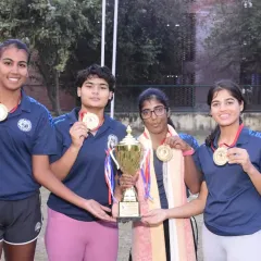 NTC player Kashish Bhatia and her teammates celebrate with their trophy and gold medals after winning the All India University Games Tennis Tournament.