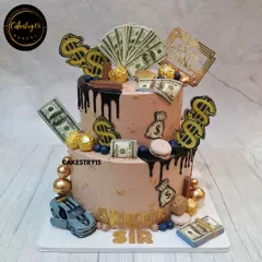 A stylish two-tier boss birthday cake with a money and luxury car theme. This 5kg black forest cake is decorated with chocolate drips, edible money, and a toy car.