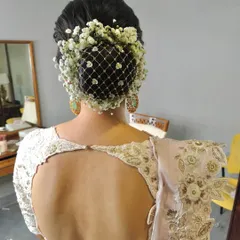Another view of the baby's breath net bun, showing its intricate detail and how it beautifully covers the hair.