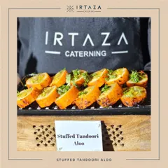 One of my team members, wearing the Irtaza branded apron, presents a platter of freshly made Stuffed Tandoori Aloo.
