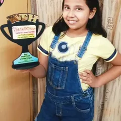 This is what it's all about. A proud winner holding her 'Outstanding Performance' trophy. I make sure our winners receive these beautiful awards to celebrate their achievement.