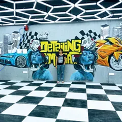 This was a huge and exciting project for a luxury car garage. I used spray paints to create this 27-foot wide graffiti mural with a sporty, automotive theme. Working on a rough surface is always a challenge, but the final result is full of energy.
