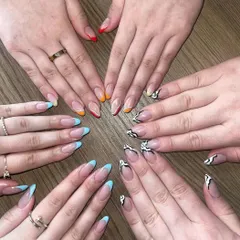 A fun group shot of different nail art styles, including animal print and colorful French tips, perfect for a group appointment.