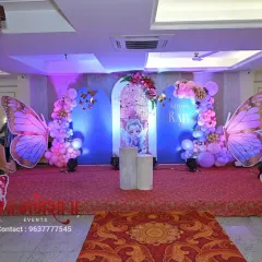 Another angle of the butterfly theme stage decoration. This view shows how the lighting and props work together to create a dreamy effect in the hall.