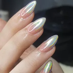 A close-up of a stunning holographic chrome finish on almond-shaped nails. The way the light reflects a rainbow of colors is absolutely mesmerizing.