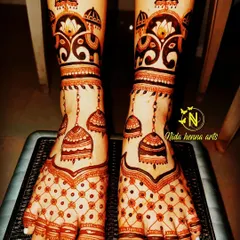 A unique bridal leg design with hanging jhumka motifs and elephant figures at the top. This is a playful and elegant choice.