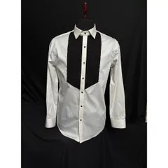 This is my classic white tuxedo shirt featuring a contrasting black textured bib. The meticulous pleating and sharp collar provide a clean and sophisticated base for any tuxedo jacket.