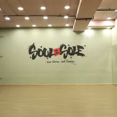 The main wall of our studio, featuring our motto: "We Dance. We Inspire." This space is ready for your next dance practice or video shoot.