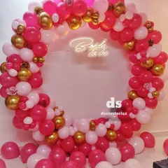 This full-ring balloon backdrop is one of our most requested items for bridal showers. We created this look with a vibrant mix of pink, white, and gold balloons, centered around a custom 'Bride to be' neon sign for the perfect photo opportunity.