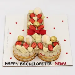 A naughty-themed tart cake for a bachelorette party, decorated with strawberries, white chocolate, and Ferrero Rocher.