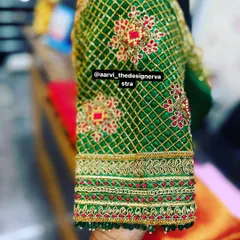 A close-up of the sleeve of the 'baraat' blouse, showing the intricate lattice work and floral motifs.
