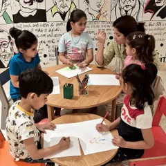 Concentration and creativity at the drawing table. During our Read-a-thon, kids listened to stories and then brought the characters and scenes to life with their own colorful illustrations.