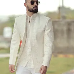 We take pride in our global clientele. Here, a client in Australia is seen in his bespoke ivory Bandhgala suit, a testament to our ability to deliver perfectly tailored elegance across continents for any wedding or formal occasion.