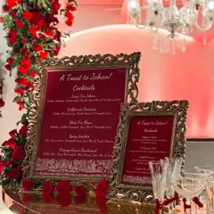 Personalization is at the heart of what we do. For this Navjote celebration, we designed elegant, custom-framed menus titled "A Toast to Jahan," featuring a curated list of cocktails and mocktails named for the occasion, set against a backdrop of lush red roses.