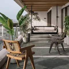 The twenty-one-foot-long sea-facing deck at Kanso House is a true urban sanctuary. We designed this space for togetherness, with a custom swing, lush greenery, and the soothing sound of a water feature, all set against the magnificent Mumbai skyline. It’s a perfect example of how I blend natural materials like Kota stone with the urban environment.