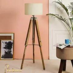 Showcasing a lighter wood finish, this adjustable tripod floor lamp fits seamlessly into contemporary and Scandinavian-inspired interiors. Its simple form and neutral shade provide excellent ambient lighting for any room.