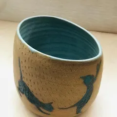 For the cat lovers, my "Midnight Mischief" bowl. This hand-thrown piece features etched feline silhouettes dancing around the outside, with a deep teal blue glaze on the inside.