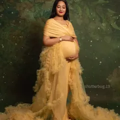 A radiant mom-to-be looking like royalty in a stunning yellow ruffled gown and a delicate crown. This portrait is all about celebrating the queen that every mother is during her pregnancy journey.