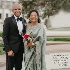 The parents of the groom, sharing in the joy of a new chapter. For the Catholic ceremony, we styled the mother of the groom in an elegant sage green saree with delicate embroidery, paired with the father's classic black tuxedo. Their looks are sophisticated, timeless, and perfectly coordinated.