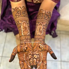 A classic Maharashtrian bridal look, featuring portraits of the bride and groom in traditional attire. The design is filled with details like peacocks and floral work.