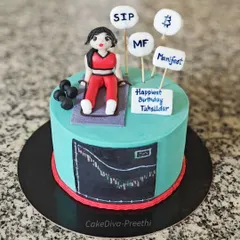 This cake was for a Tahsildar who is also a fitness freak and financial investor. I included a hand-painted stock chart, fondant dumbbells, and signs for SIP and Bitcoin to represent all her interests.
