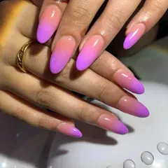 Mastering the ombre technique is essential for any nail tech. We teach you how to create a seamless color blend, like this pink and purple gradient on long, almond-shaped nails.