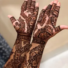 This Gulf-style design is filled with dense, intricate patterns. It combines floral elements with detailed geometric fills and shading, covering the hands completely for a rich and luxurious feel.