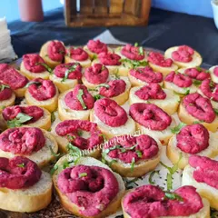 A glimpse of a corporate office inauguration event we catered. This image shows our colorful beetroot hummus crostini, a sophisticated and delicious appetizer for professional gatherings.