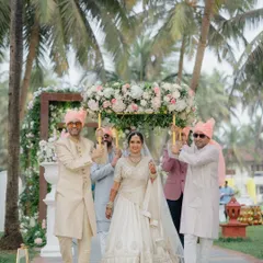 The bride's grand entrance under a phoolon ki chadar at her Goa wedding. A beautiful and traditional moment filled with anticipation and joy.