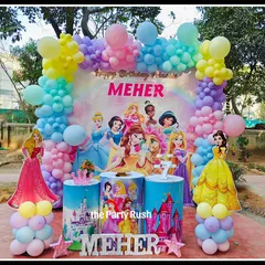 A party fit for royalty, this Disney Princess theme for Meher's 7th birthday features a backdrop with all her favorite princesses. The pastel rainbow balloon arch and castle-themed pedestals complete the royal celebration.