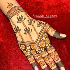 This design is a beautiful symphony of traditional Indian motifs. It features jhumka earrings, lotus flowers, and a central mandala, creating a different yet complementary look on each hand.