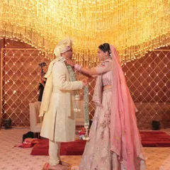 A beautiful varmala moment under a canopy of golden light. For this pastel-themed wedding, I focused on creating an atmosphere of soft elegance, where every detail, from the decor to the lighting, felt timeless and romantic.