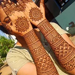 This design provides good coverage up the arm but uses simpler, repeating patterns like mandalas and bands. It's a great choice for bridesmaids or family members.